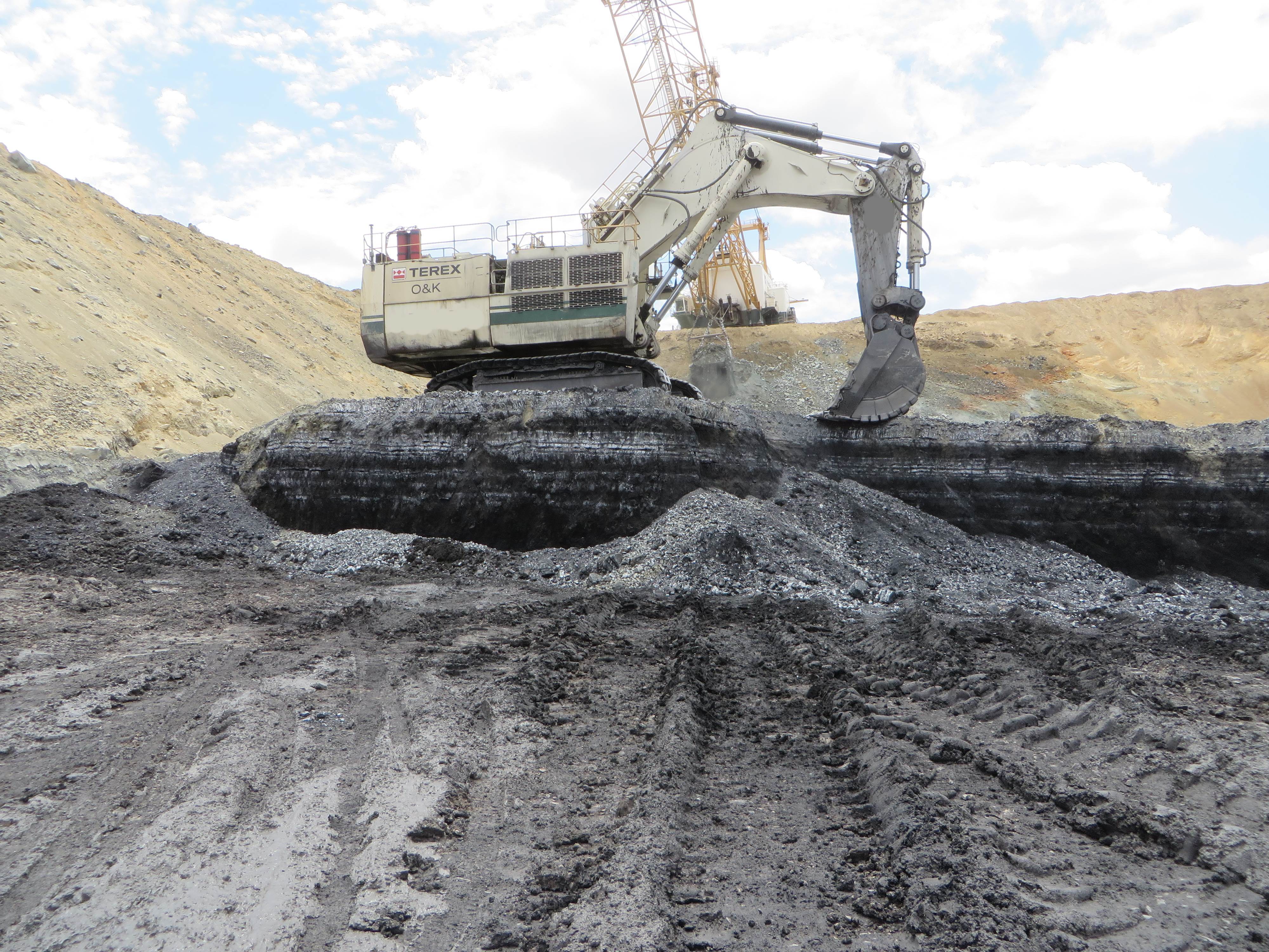 Large Excavator Separating Heat Affected Coal From Good Coal