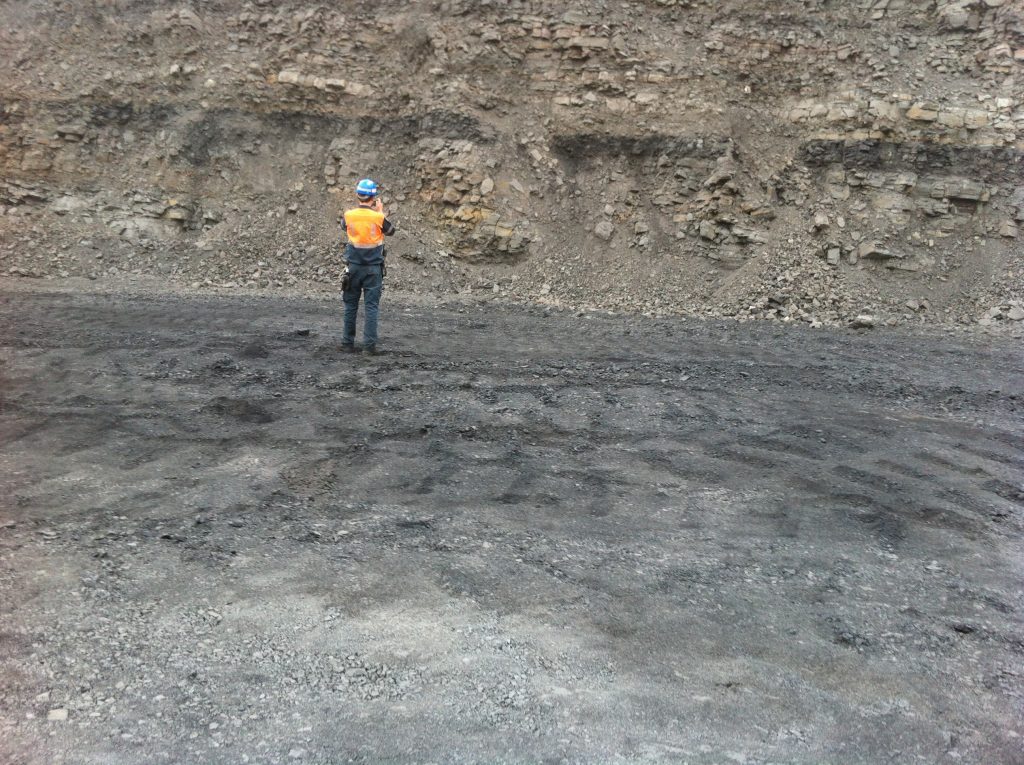 Mine Geologist Taking Photo of Highwall